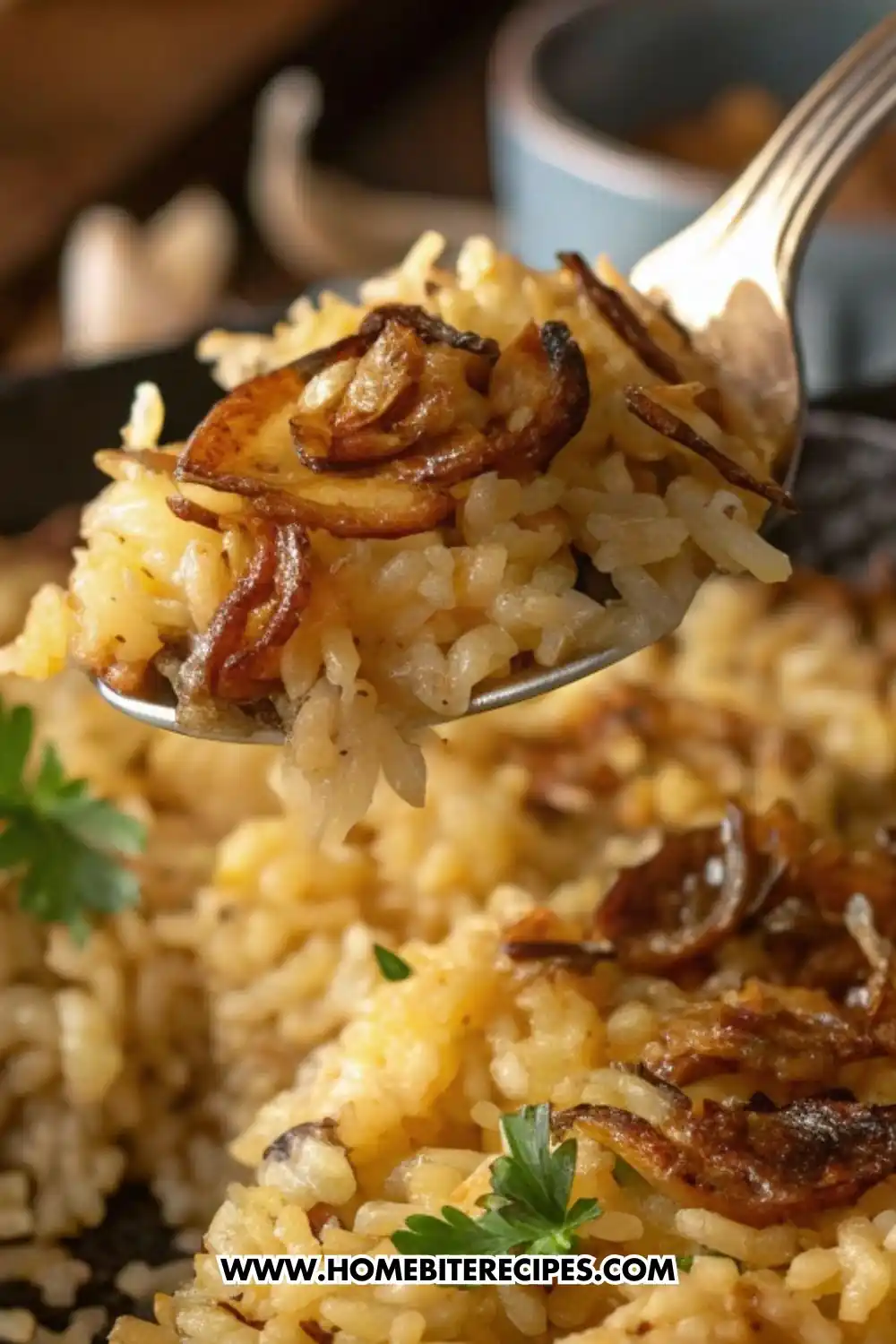 Close-up of French onion butter rice topped with caramelized onions, served on a spoon with fresh parsley garnish in the background.
