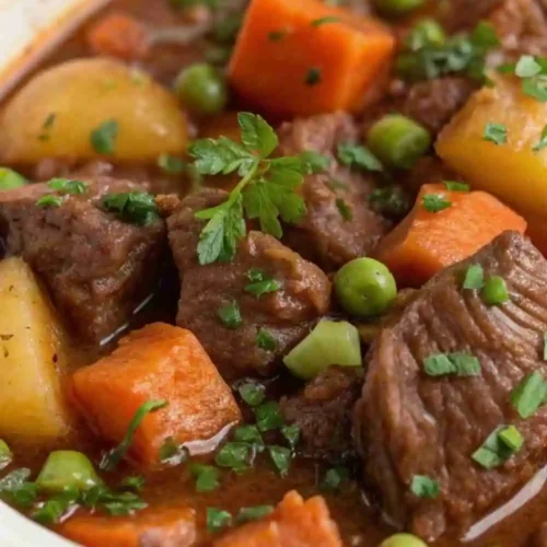 Classic hearty beef stew with tender beef chunks, potatoes, carrots, and peas in a rich savory broth.