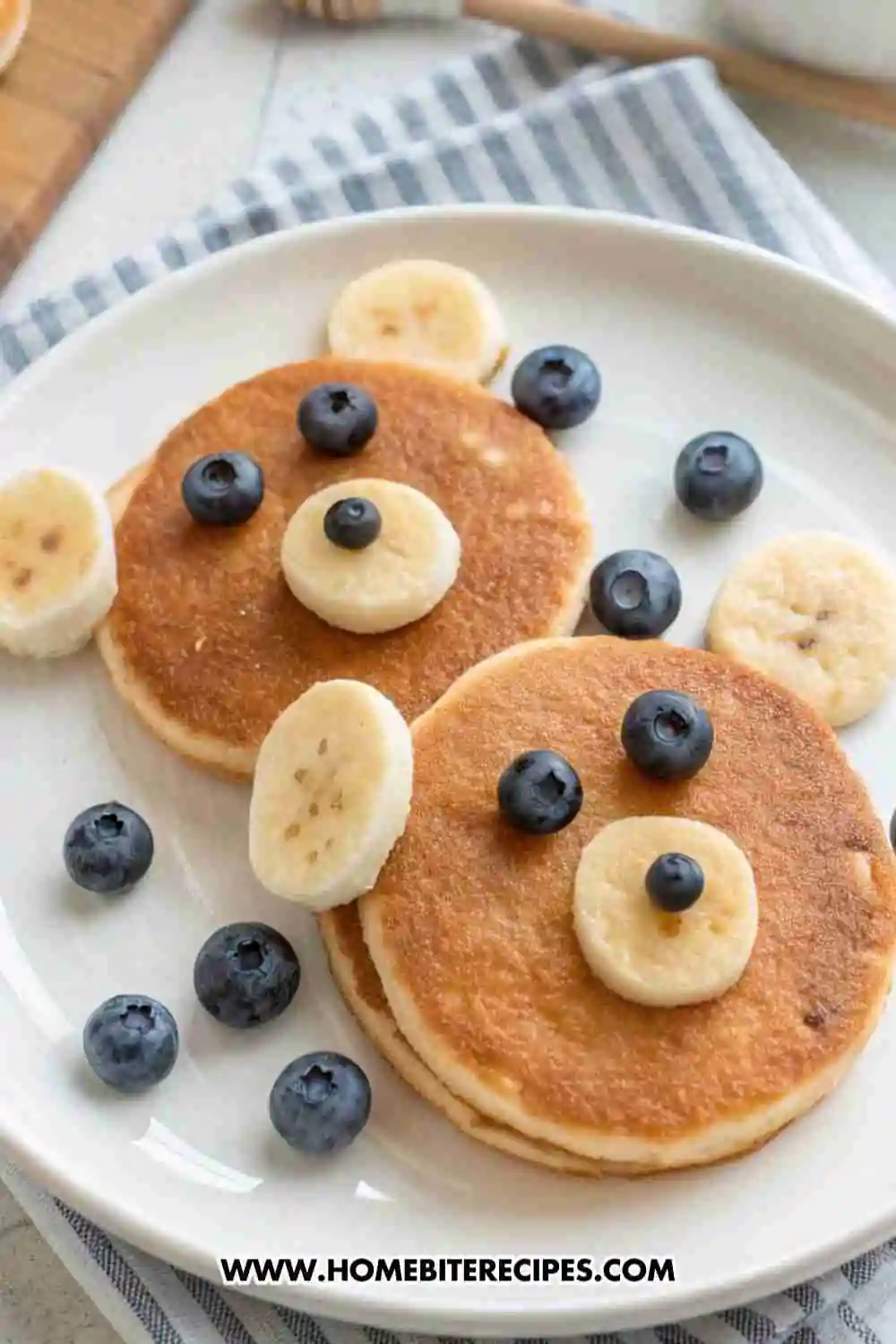 Cute bear face pancakes made with gluten-free batter, decorated with banana slices and blueberries for a fun kids’ breakfast.