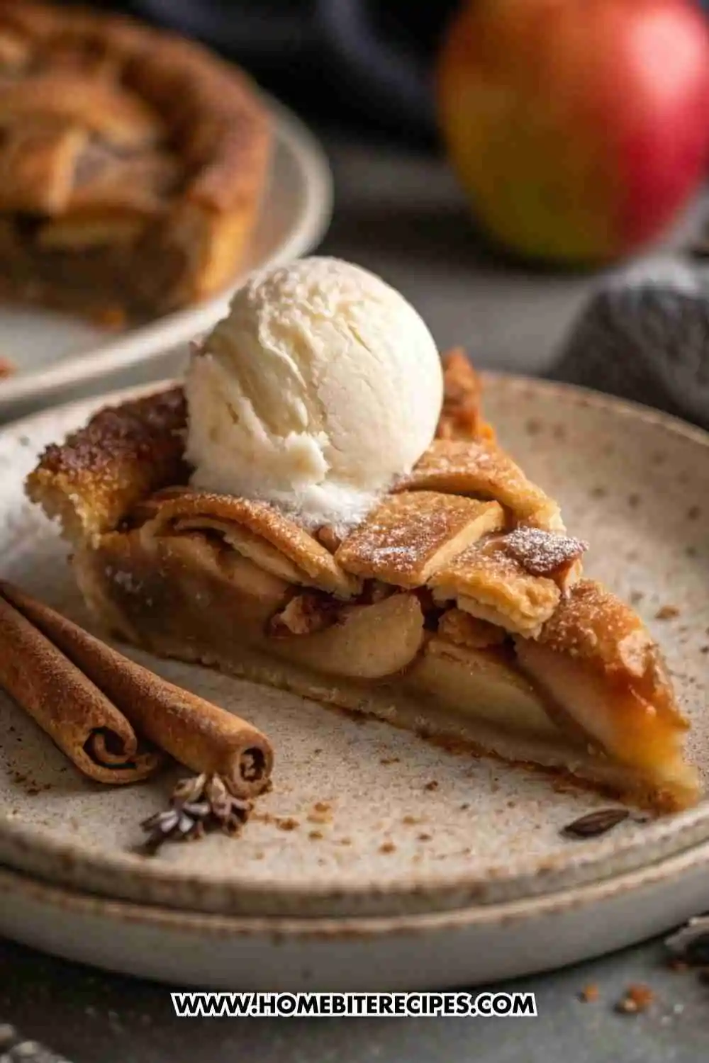 Homemade Apple Pie Slice with Vanilla Ice Cream, served on a ceramic plate with cinnamon sticks.