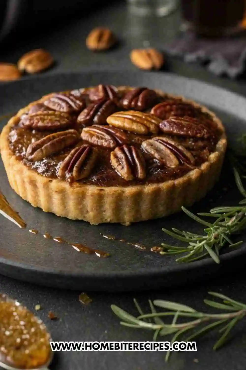 Mini pecan tart with golden buttery crust, gooey caramel filling, and roasted pecans on top.