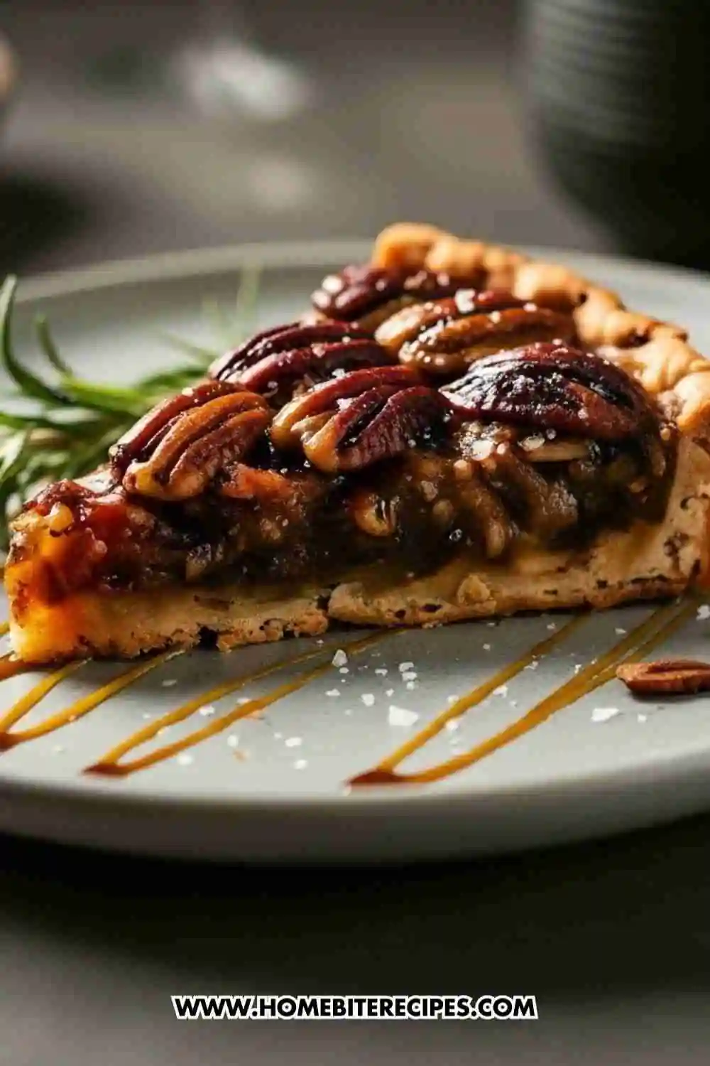 A slice of modern pecan pie with glossy caramelized pecans, flaky crust, sea salt flakes, and caramel drizzle on a plate.