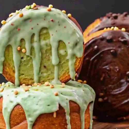 Soft baked New York Rolls topped with smooth matcha green tea glaze and chocolate glaze, decorated with sprinkles.