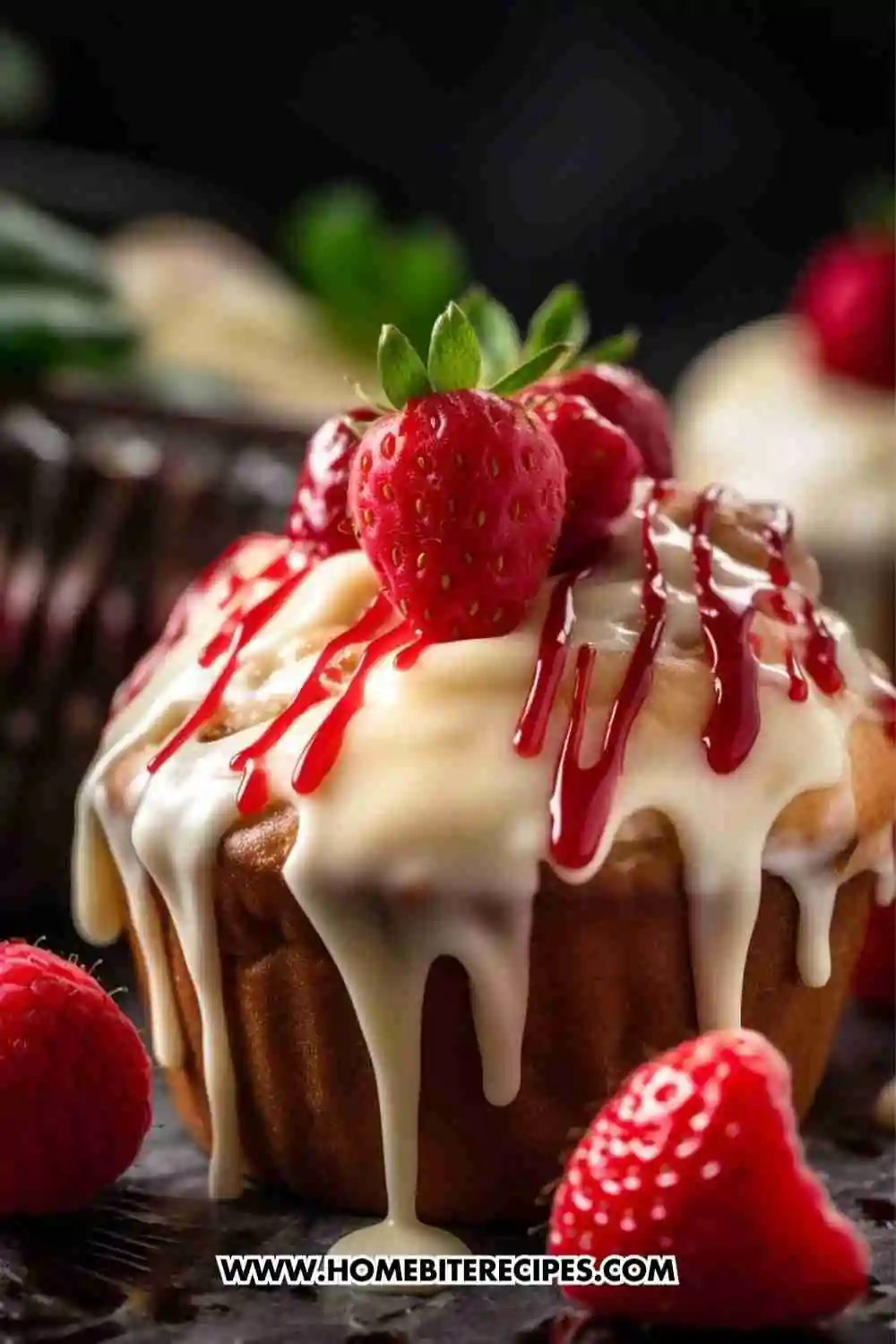 A moist vanilla cupcake topped with cream cheese frosting, strawberry drizzle, and fresh strawberries, beautifully styled with a dark background.
