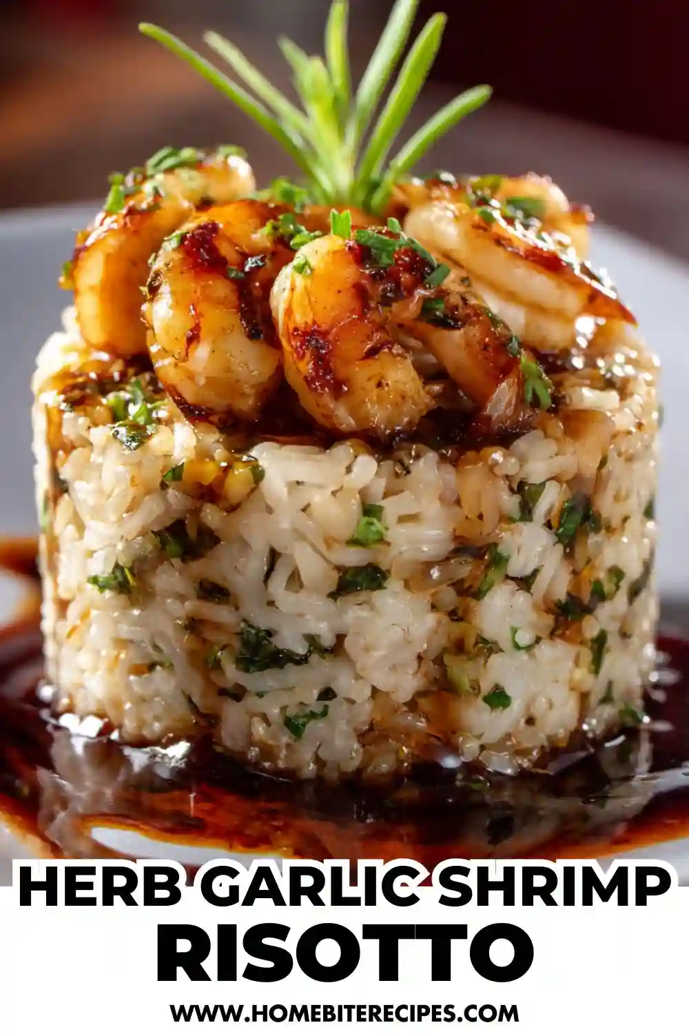 Close-up photo of herb garlic shrimp served on top of creamy risotto shaped into a round mold, drizzled with sauce and garnished with fresh herbs.
