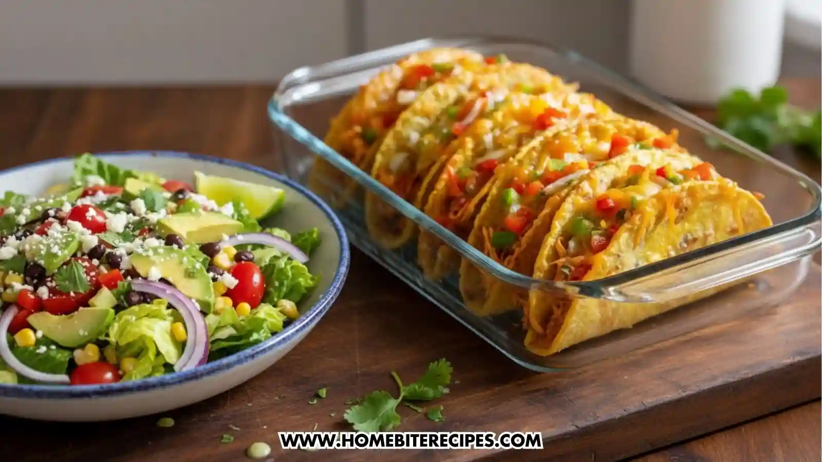 A glass baking dish filled with several Easy Cheesy Baked Chicken Tacos served with a Mexican salad