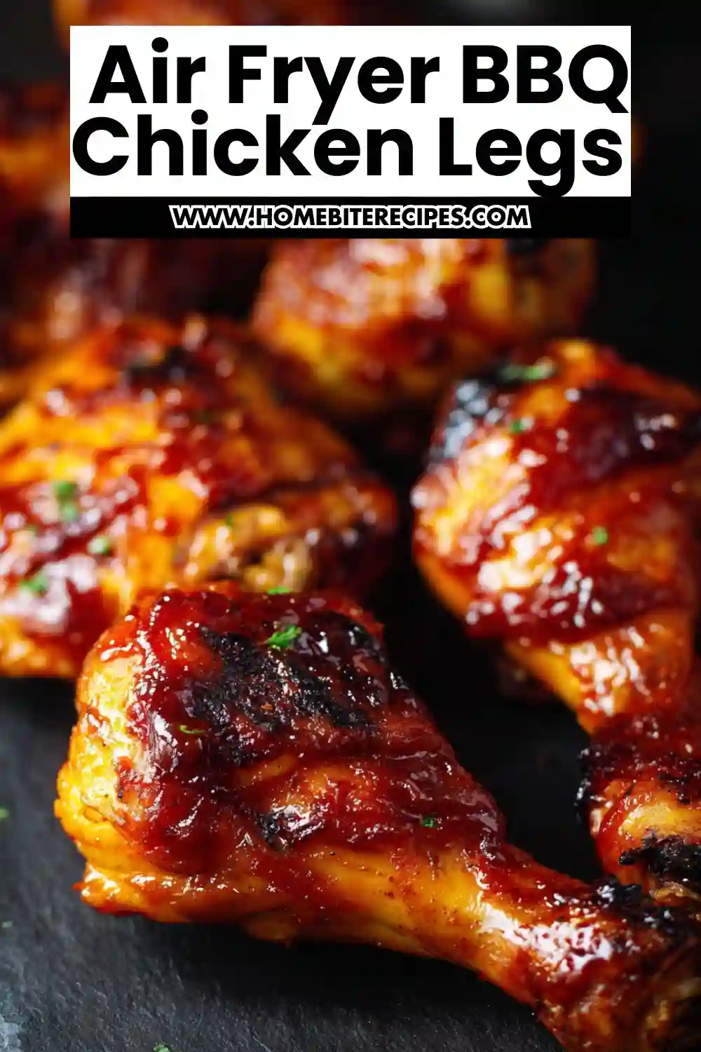 Close-up of juicy BBQ chicken legs cooked in an air fryer, coated in a glossy barbecue sauce with a perfectly caramelized finish.