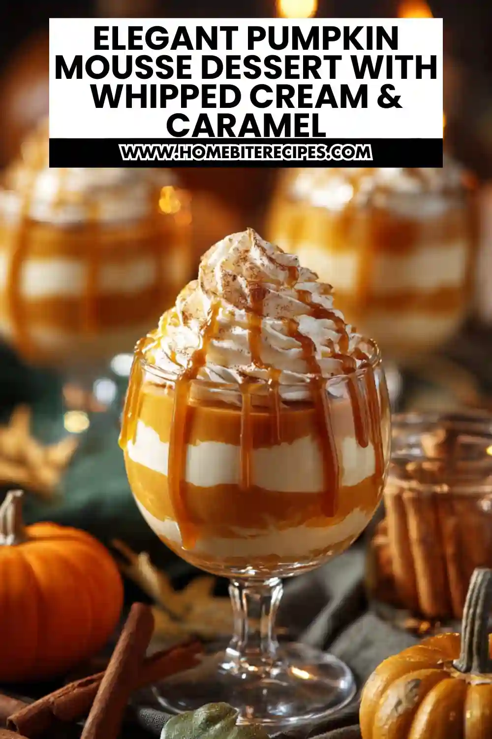 Layered pumpkin mousse dessert in a glass topped with whipped cream and caramel drizzle, surrounded by pumpkins and cinnamon sticks for a fall setting.