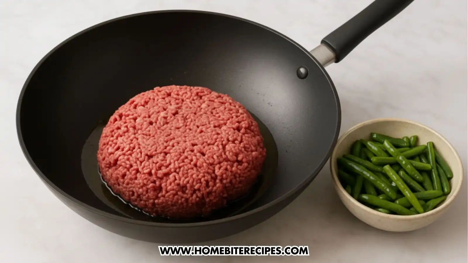 A Heated vegetable oil in a wok where ground beef is added, and beside it a bowl of Cooked green beans