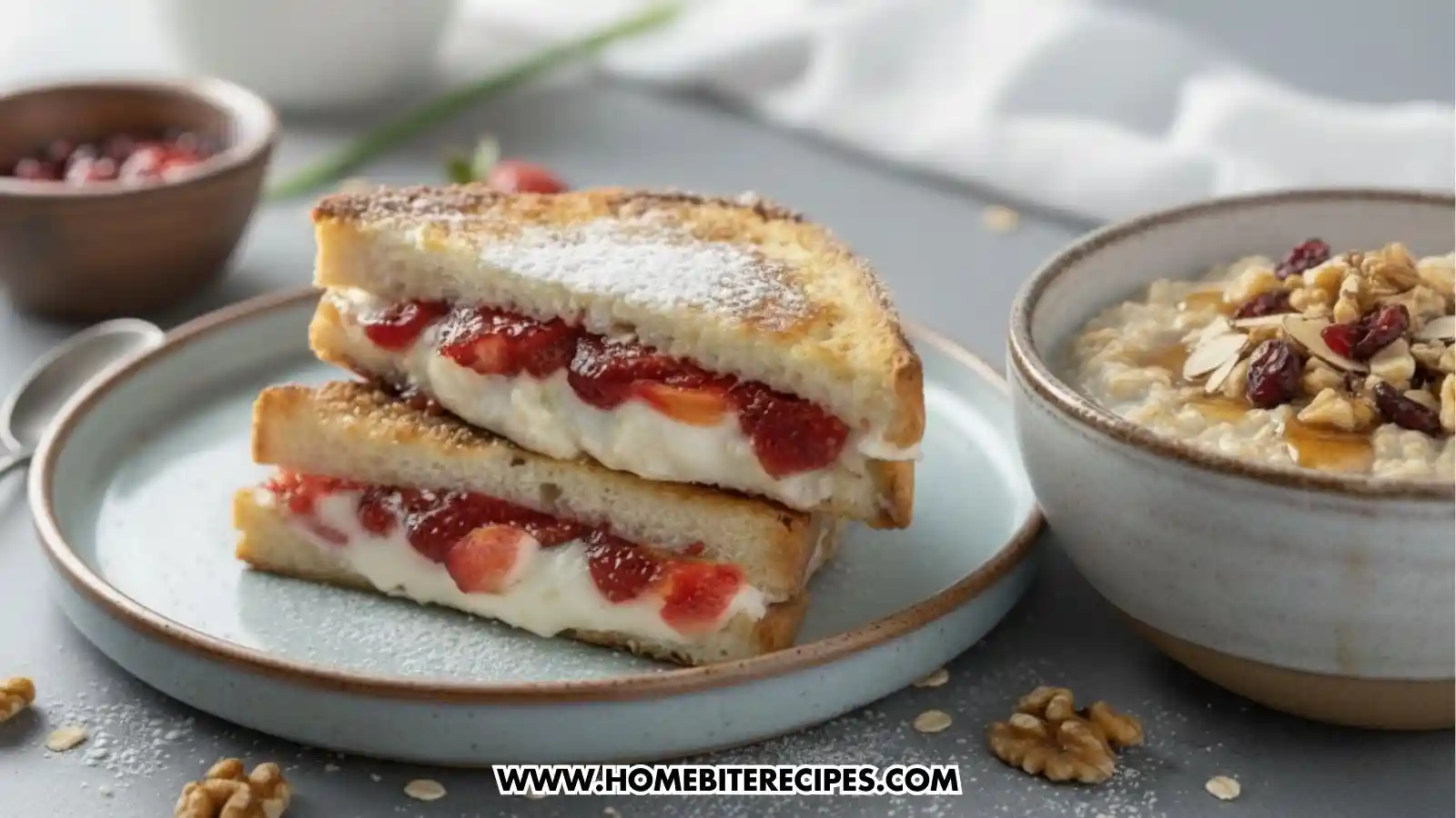 Close-up of golden Strawberry and Cream Stuffed French Toast served with a comforting bowl of oatmeal topped with dried fruit