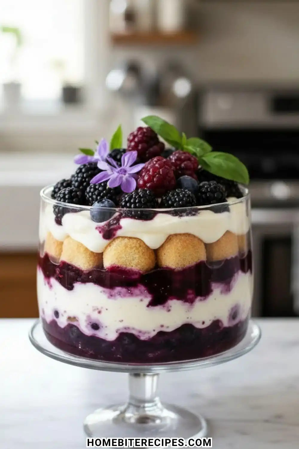 A layered Berry Tiramisu Trifle in a glass bowl featuring ladyfingers, creamy mascarpone, and mixed berry compote topped with fresh blackberries and raspberries.
