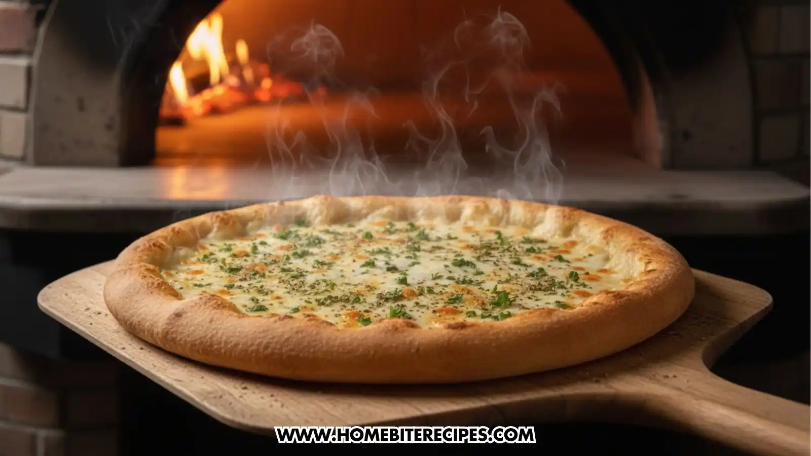 A freshly baked cheesy white garlic pizza sits on a wooden pizza peel, steaming hot as it is pulled from a brick oven with a glowing fire in the background. The pizza features a golden-brown, puffed crust and is topped with melted white cheeses and a generous sprinkle of fresh green herbs and dried seasonings.