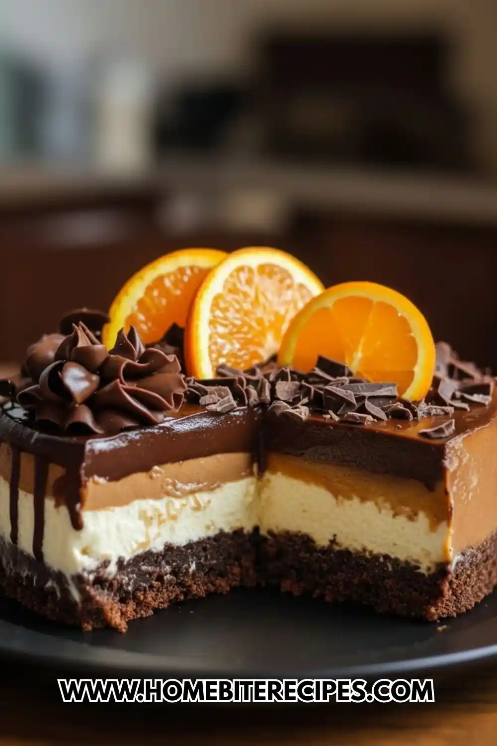 A decadent sliced Chocolate Orange Cheesecake with distinct layers of chocolate crust, vanilla cream, and orange-infused mousse topped with ganache and fresh orange slices.