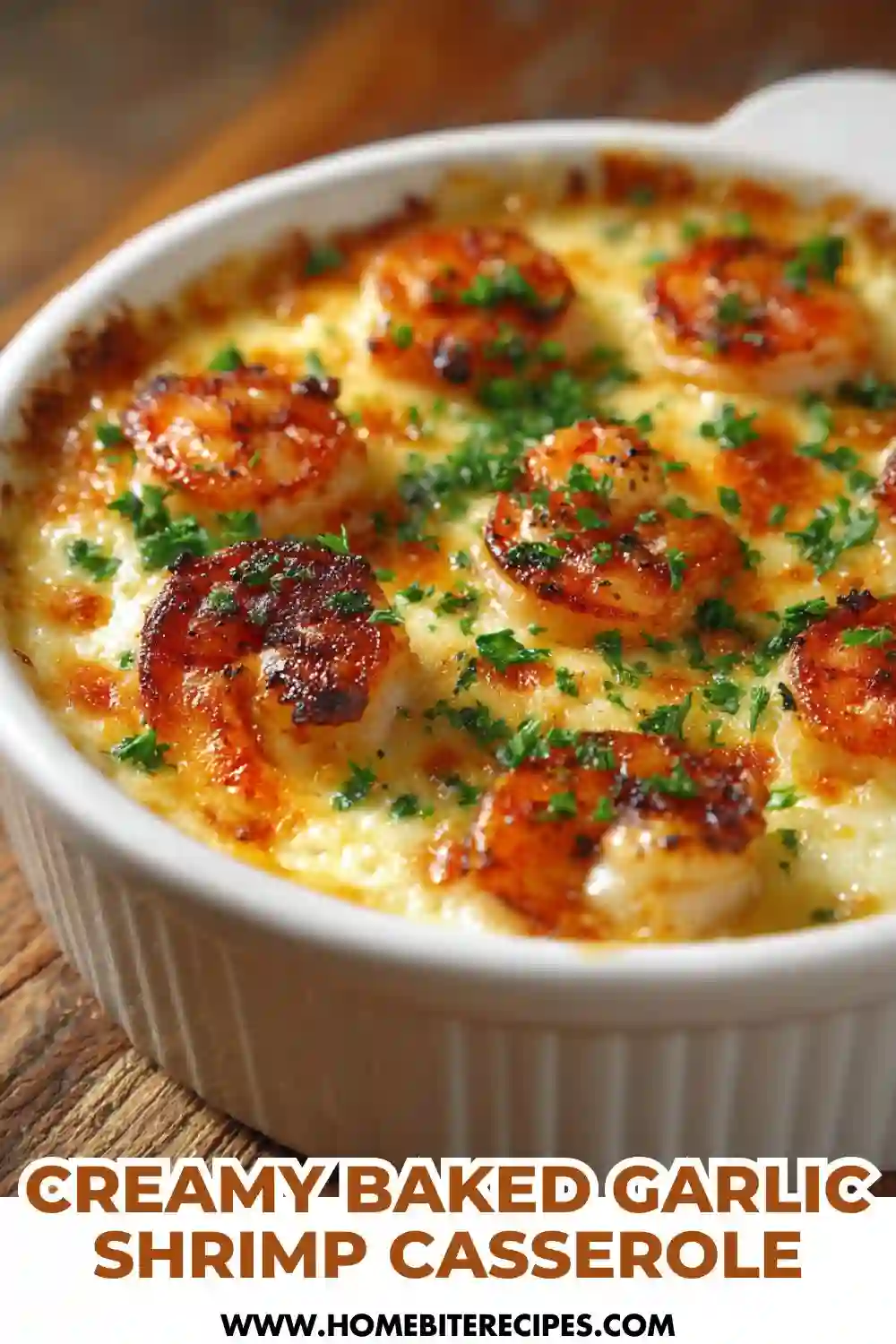 A creamy baked garlic shrimp casserole topped with golden-brown seared shrimp and freshly chopped parsley in a white ceramic baking dish.