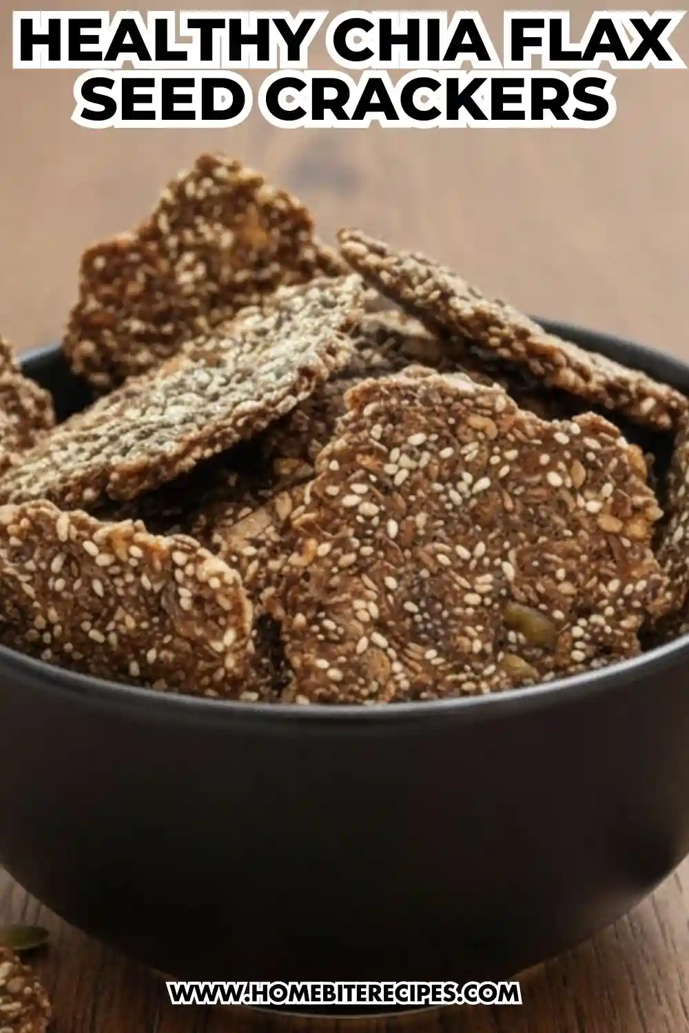 A bowl of crispy, homemade Chia Flax Seed Crackers showing a rich texture of sesame, chia, and flax seeds.