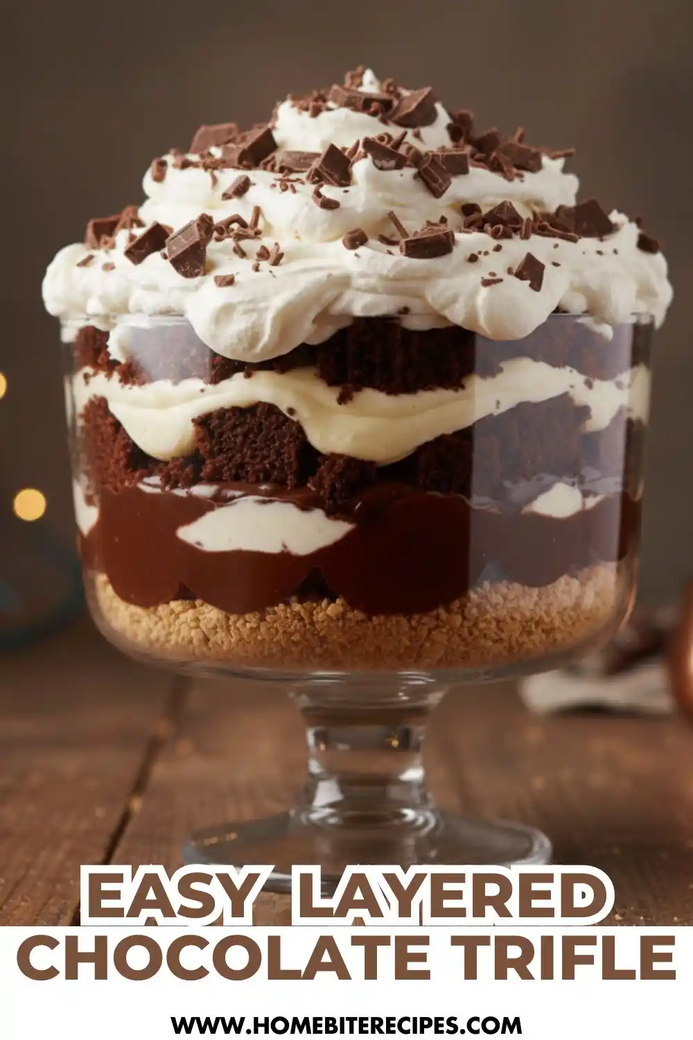 Layered no-bake chocolate dessert cup with chocolate cake crumbs, creamy vanilla and chocolate layers, topped with whipped cream and chocolate shavings in a glass dish.