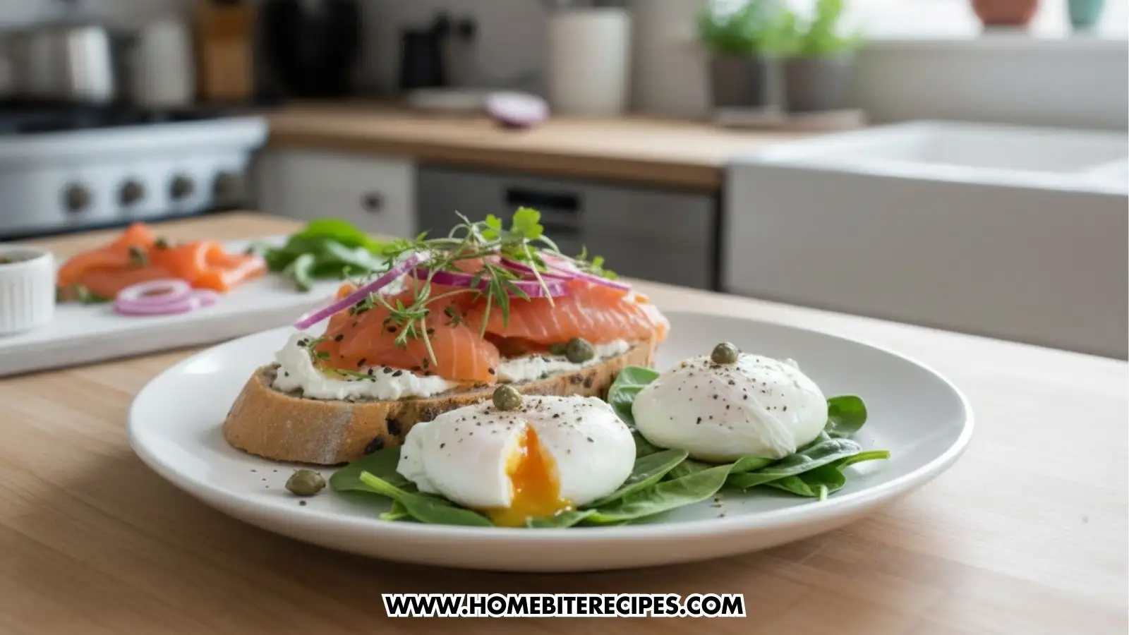 A plate featuring a large slice of Smoked Salmon And Cream Cheese Toast topped with a thick layer of cream cheese, several folds of fresh smoked salmon, thinly sliced red onions, capers, and fresh microgreens. Beside the toast are two perfectly poached eggs resting on a bed of fresh baby spinach; one egg is sliced open to reveal a runny golden yolk. The dish is presented on a white plate in a bright, modern kitchen setting.