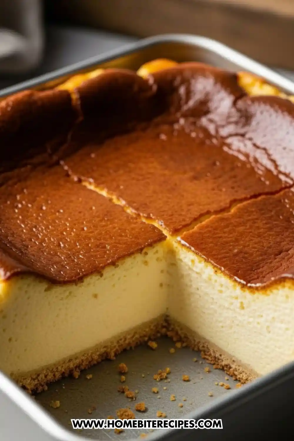 Ultra fluffy Japanese cotton cheesecake with a golden top and soft airy interior baked in a square pan, sliced to show its light sponge texture