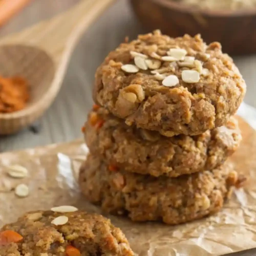 Stack of healthy carrot oatmeal cookies made with rolled oats and grated carrots on parchment paper