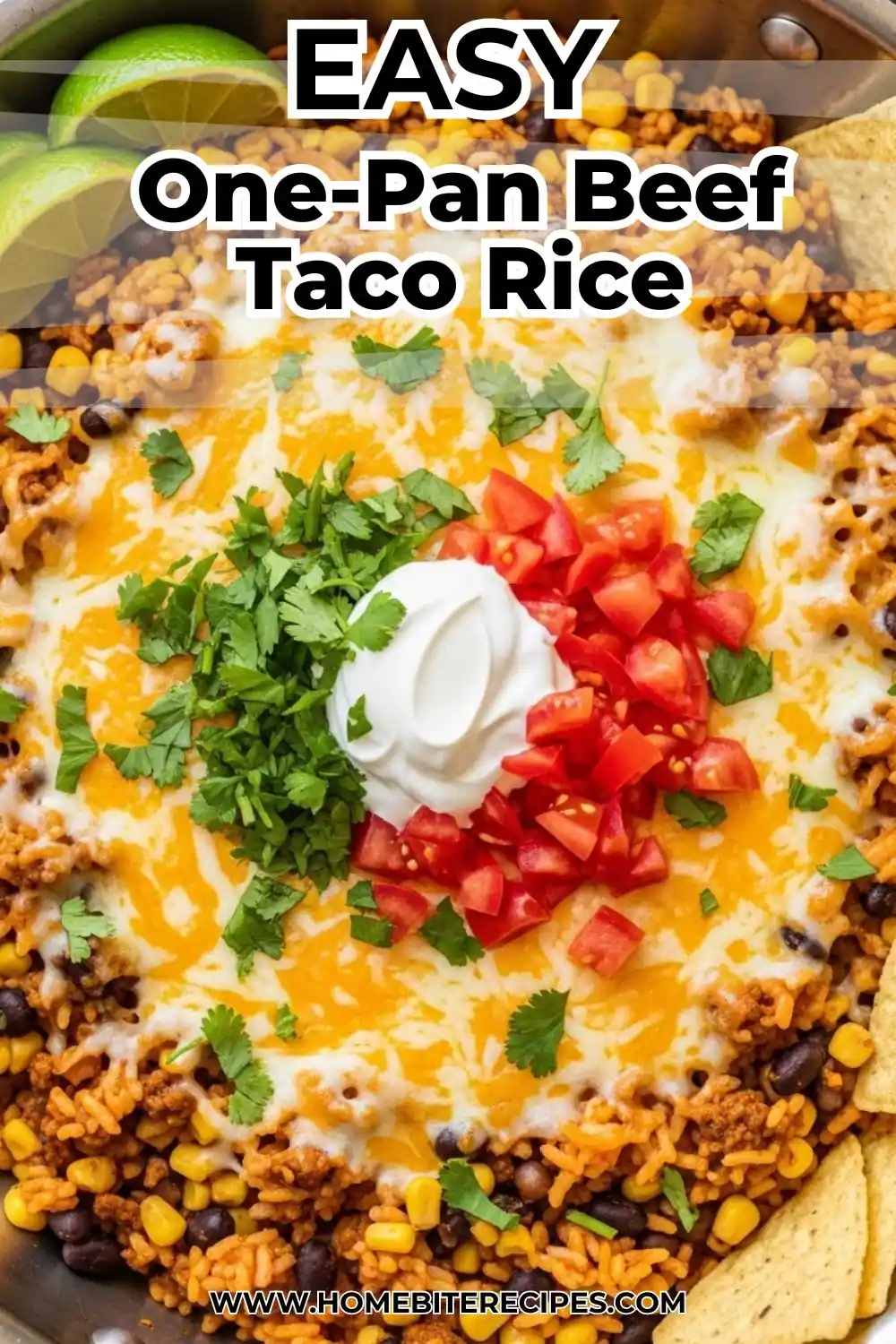 One-pan beef taco rice skillet with melted cheese, black beans, and corn, topped with sour cream, tomatoes, and cilantro.