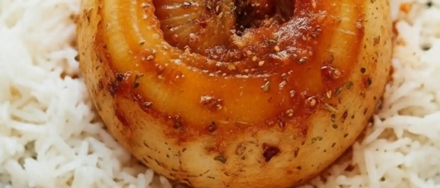 close up of whole, tender roasted onion with a caramelized golden-brown glaze and savory herbs, served prominently in the center of a bed of fluffy white basmati rice on a matte black plate.